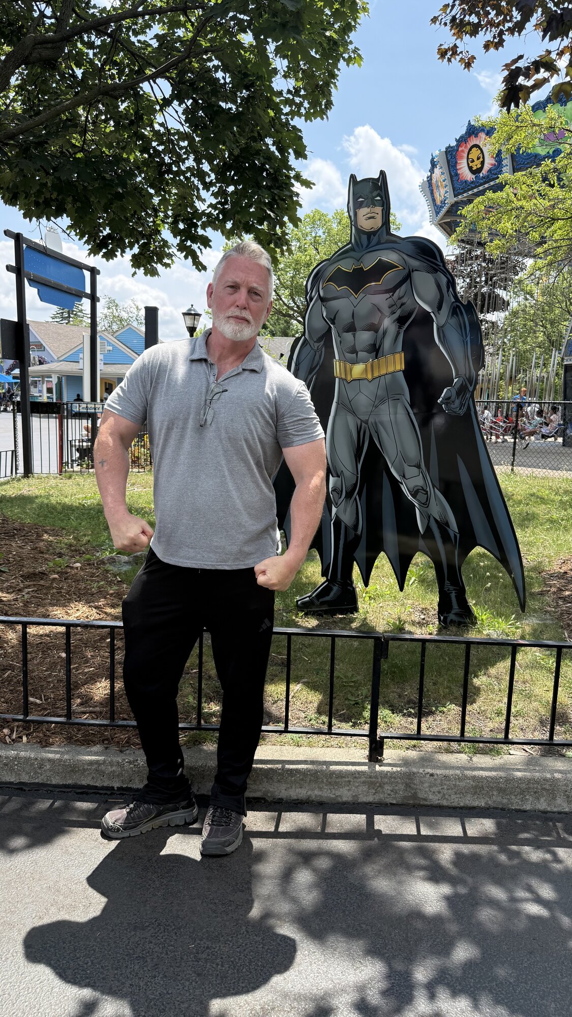 Doug Mahnke flexing beside a Batman figure
